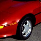 A red sports car after a dent & scratch removal program.